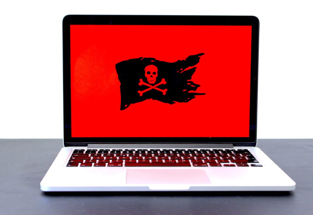 Laptop with Red Background and Pirate Flag